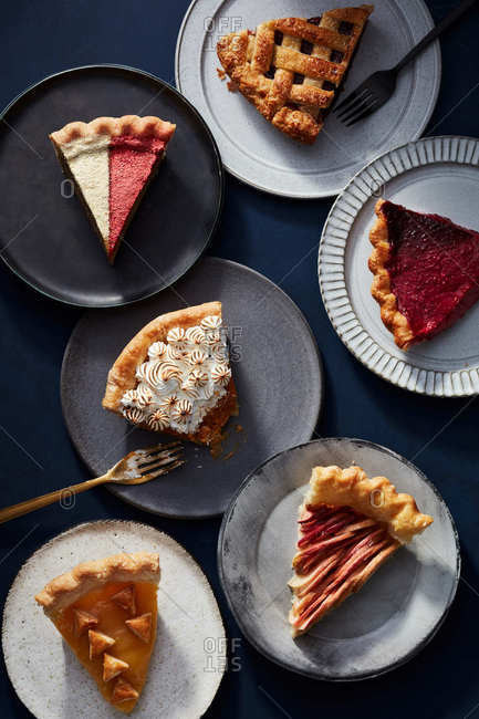 Overhead view of a variety of pie slices and bite taken out of one
