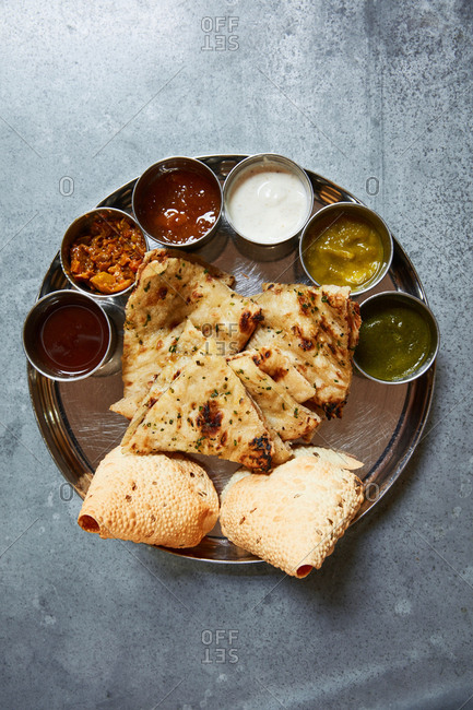 Indian appetizer dish with flatbread and dipping sauces