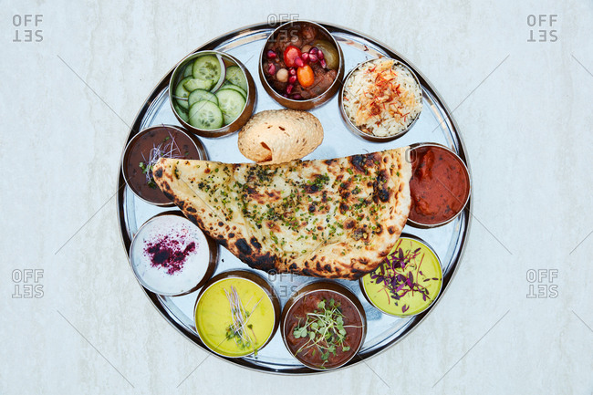 Indian appetizer with flatbread and various dipping sauces