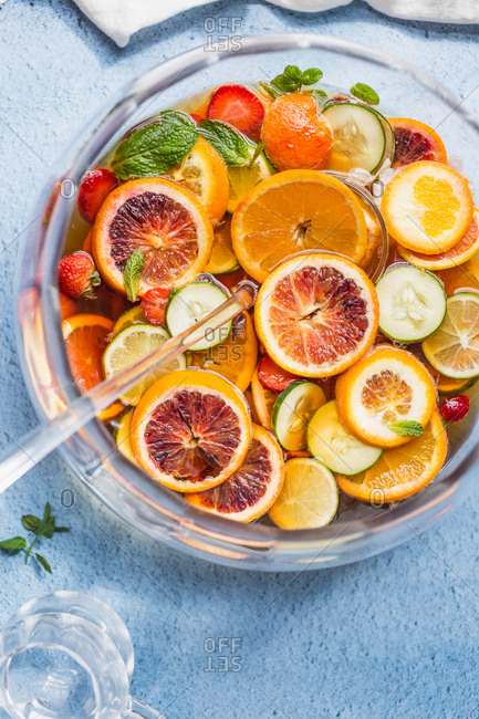 Cut up fruit in punch bowl with cocktail punch
