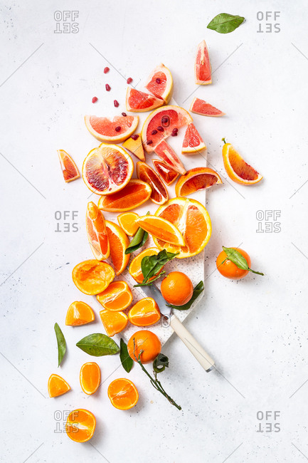 Citrus fruit cut on cutting board with white marble background
