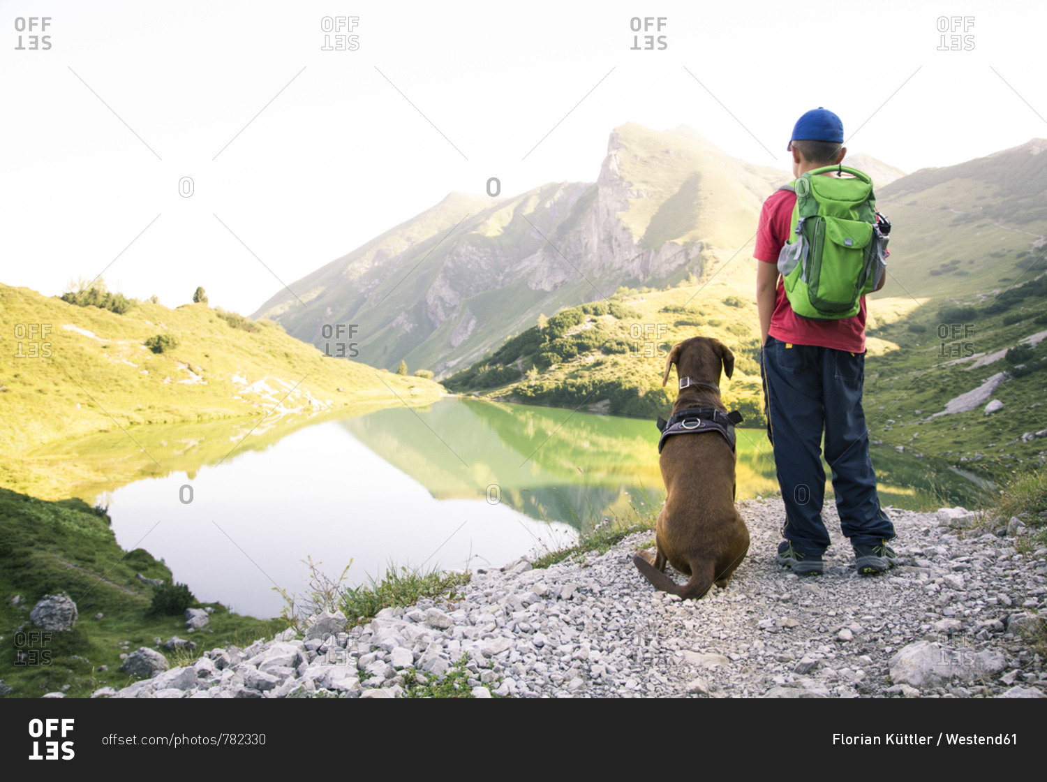 Austria- South Tyrol- young boy standing next to his dog