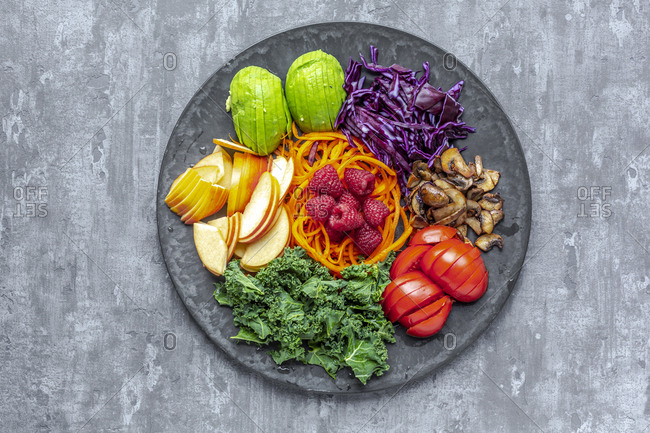 Kale avocado salad with red cabbage- tomato- fried mushroom- carrot- apple and raspberry