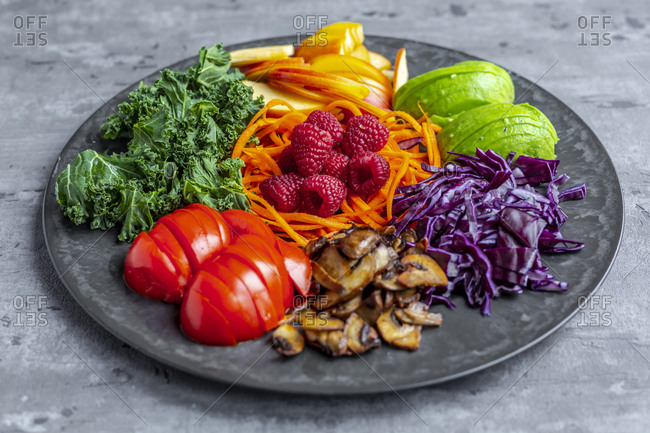 Kale avocado salad with red cabbage- tomato- fried mushroom- carrot- apple and raspberry