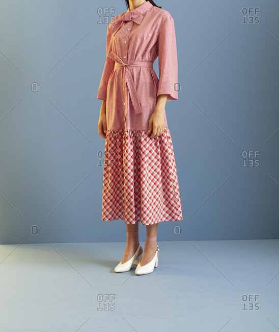 Studio shot of a model wearing checkered dress