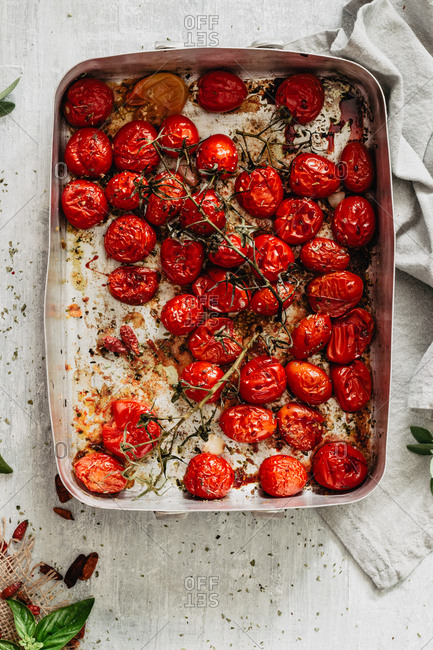 Roasted juicy cherry tomatoes into a baking tray