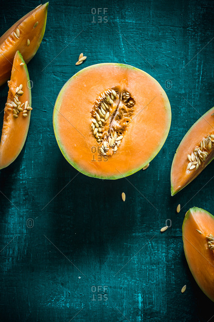 Juicy orange melon onto a green surface