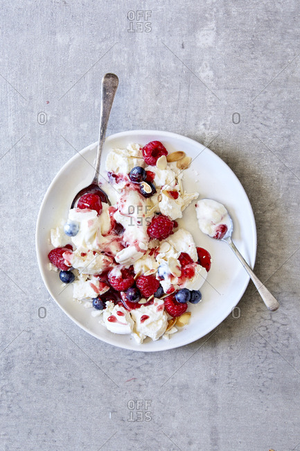 Raspberry and blueberry eton mess with two spoons