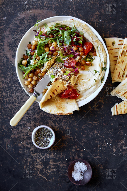 Hummus dip with pita bread and knife