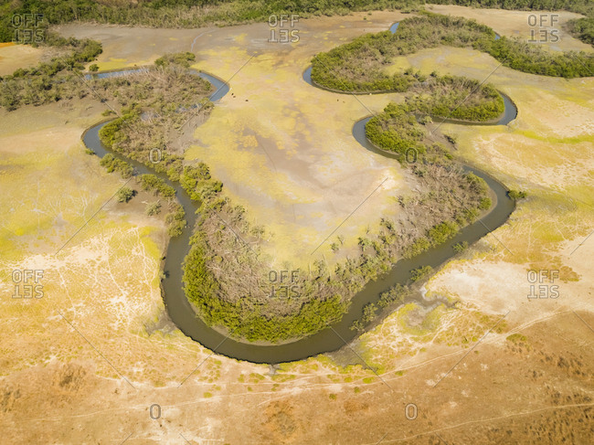 Aerial view of a serpentine stream with riparian forest, Brazil.