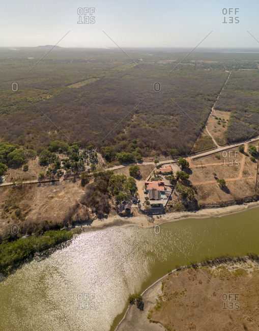 Aerial view of private residence near turbid river water, Brazil.