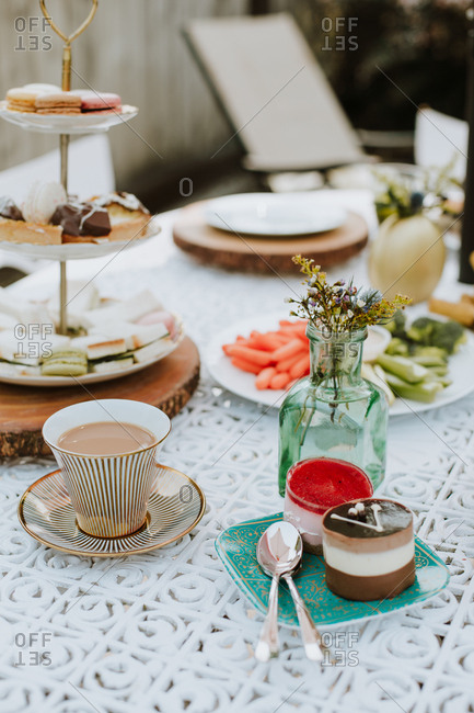 Small Flower Arrangement By Desserts On An Outdoor Table Stock Small Flower Arrangement By Desserts On
