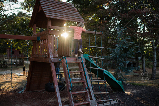 Little girl climbing a playground