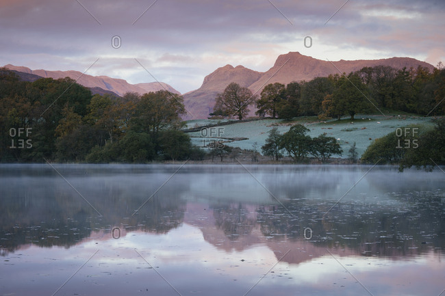 Langdale Pikes at dawn from Loughrigg Tarn, Lake District National Park, UNESCO World Heritage Site, Cumbria, England, United Kingdom, Europe