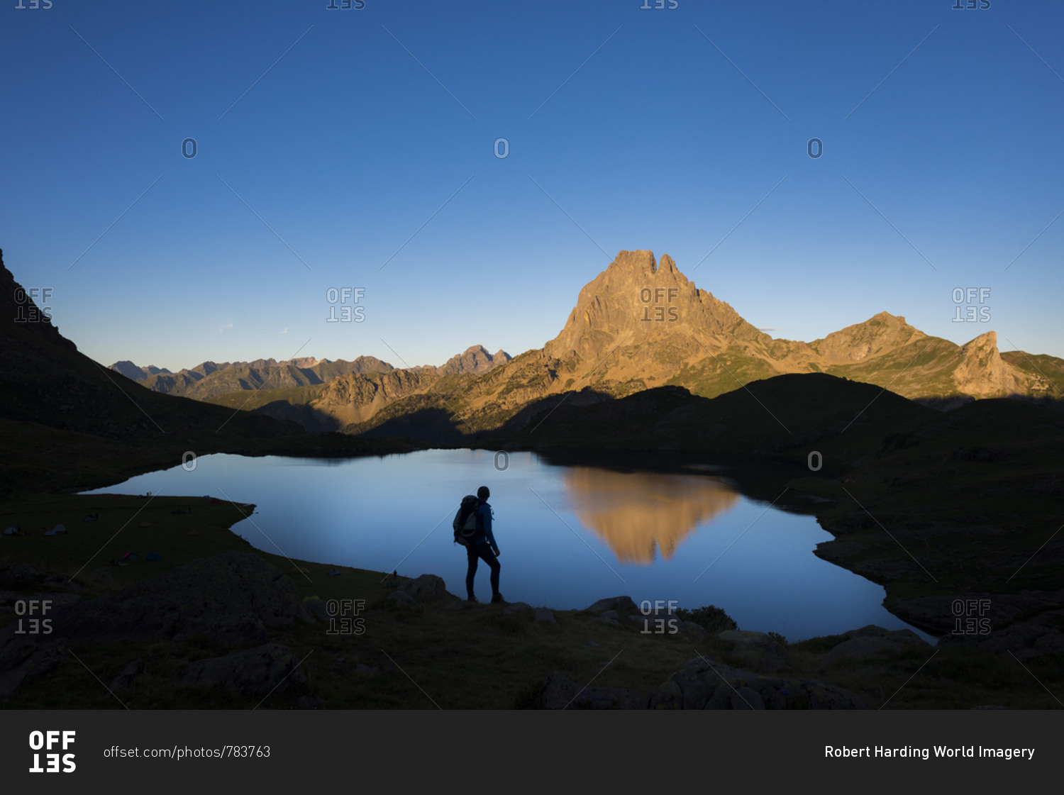 Taking in the view of Midi d\'Ossau beyond Lac Gentau beside the GR10 trekking route in the French Pyrenees, Pyrenees Atlantiques, France, Europe
