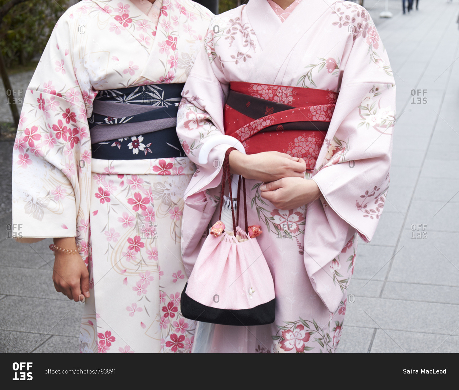 Fushimi Inari-Taisha, Kyoto Prefecture, Japan- April 5, 2017: Two women dressed in Kimonos pose for a photo, cutaway