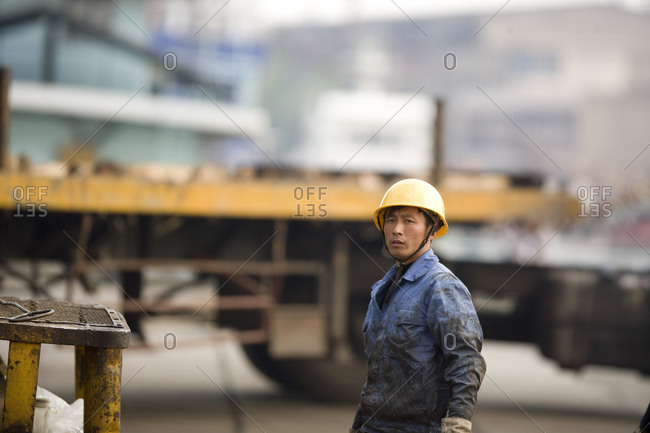 Portrait of a mid-adult construction worker at a shipping yard.
