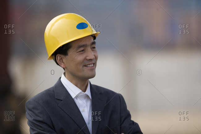 Mid-adult businessman standing in a shipping yard.