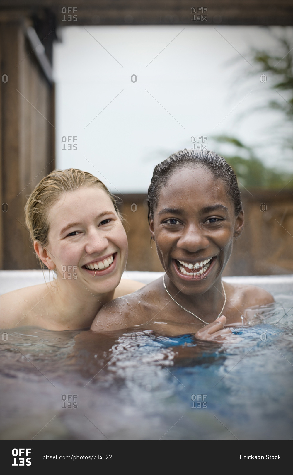 Portrait Of Smiling Young Lesbian Couple Sitting In A Hot Tub Stock 