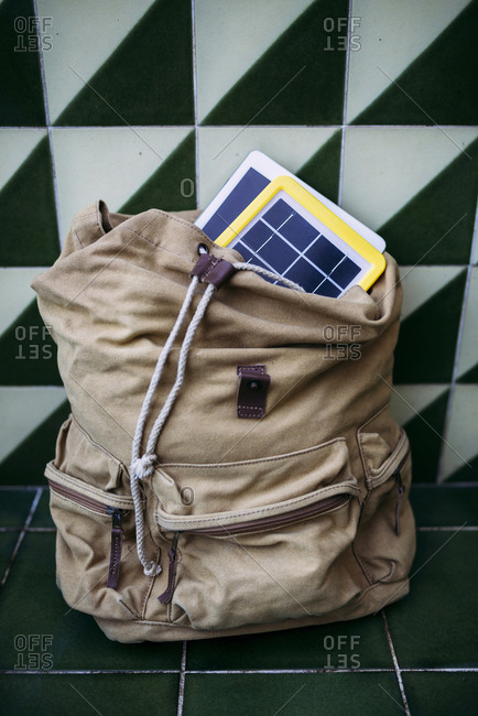 Solar panel charger and a tablet in a backpack
