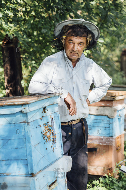 Russland- Portrait of beekeeper at beehive