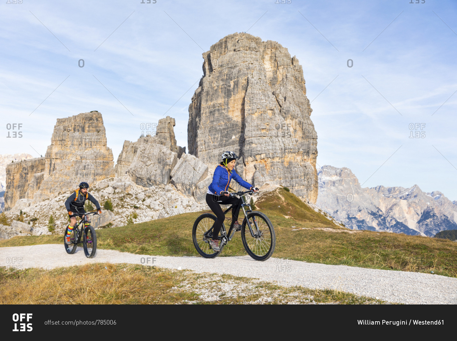 Italy- Cortina d'Ampezzo- two people cycling with mountain bikes in the Dolomites mountains