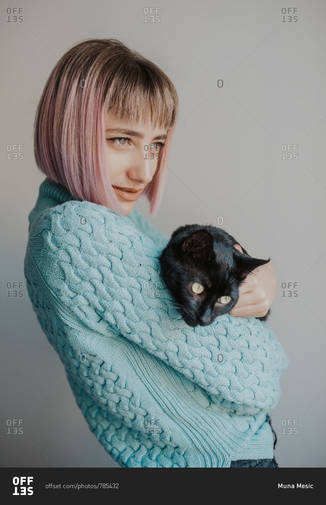 Woman poses with her black cat