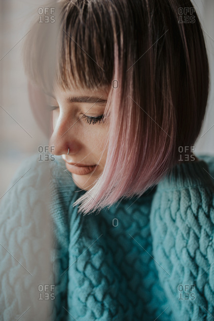 Woman in a comfortable sweater closes her eyes