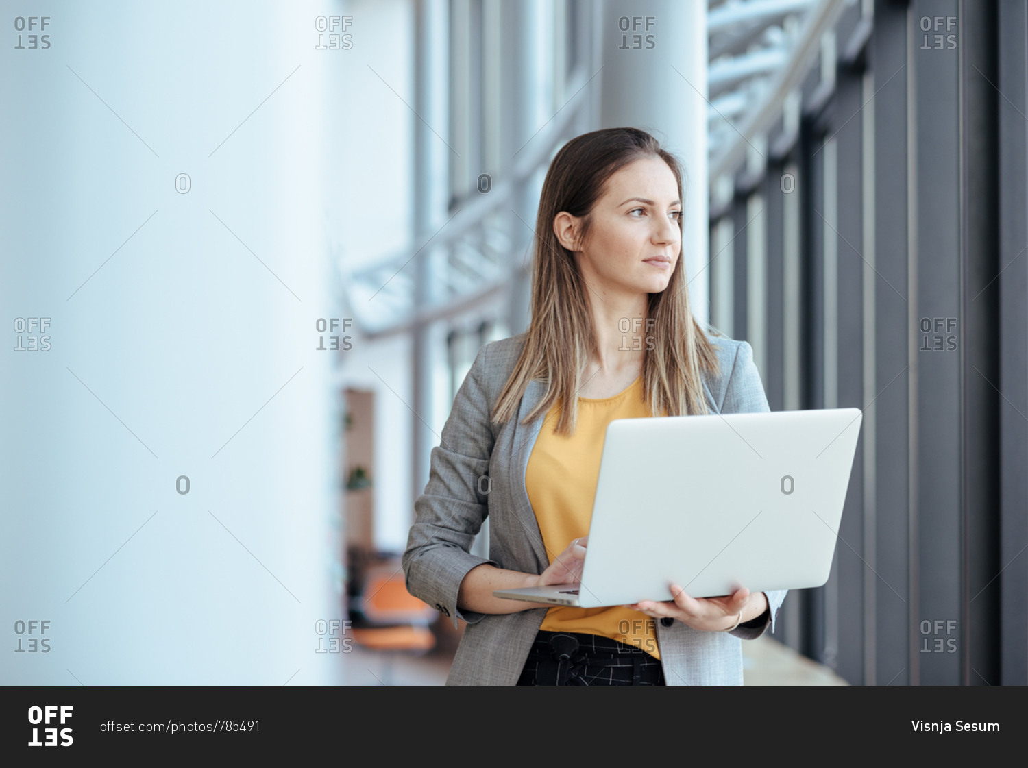 Business woman holding her computer