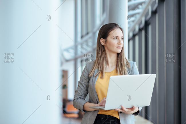Business woman holding her computer