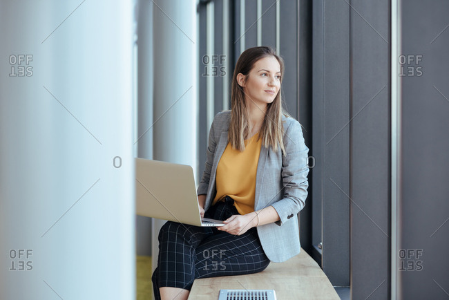 Business woman holding her computer