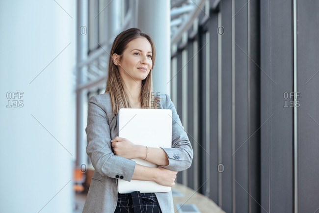 Business woman holding her computer