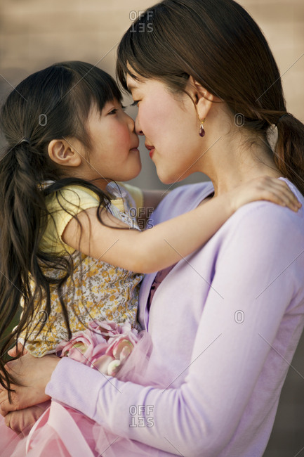Mother and daughter touching noses.