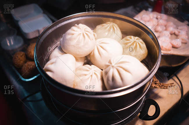 From above set of big meat dumplings in pot near cutting board with fresh minced meat in Auckland, New Zealand