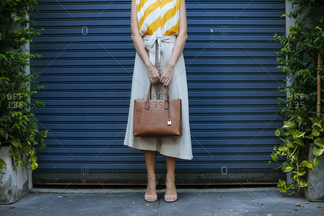 Free Photo | Image of happy young woman going on shopping holding her purse  and smiling excited ready to go stand