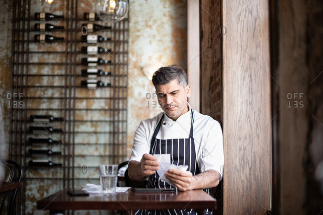 Male chef working on accounts in restaurant