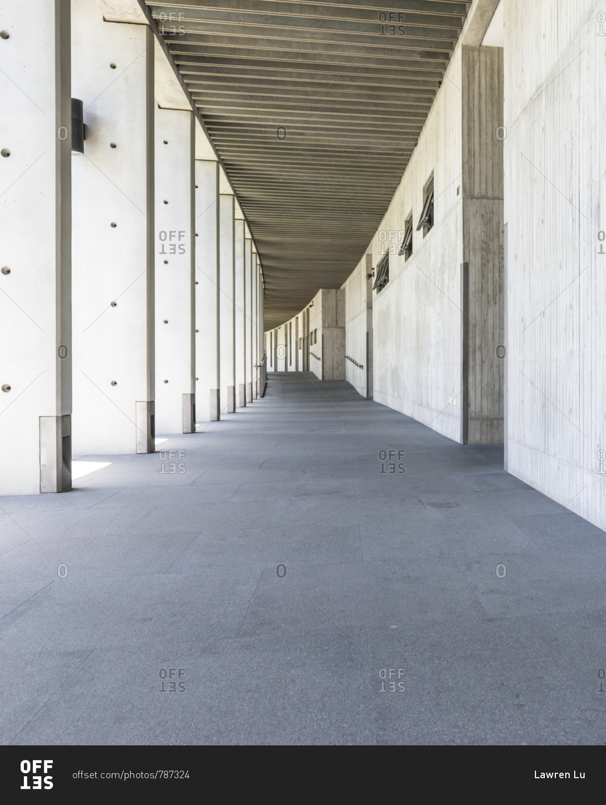 Cement corridor of wall on one side and pillar on another side stock photo  - OFFSET