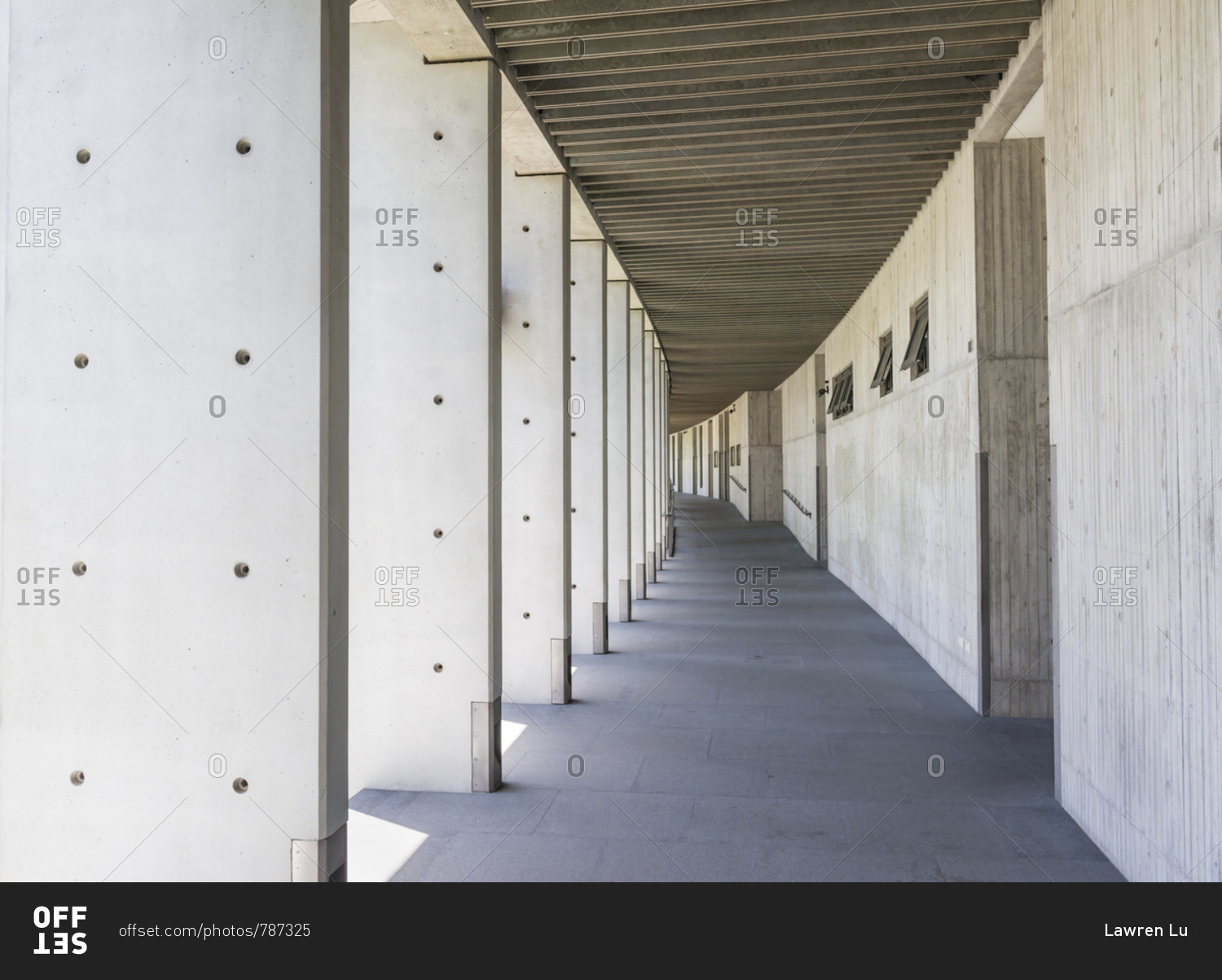 Cement corridor of wall on one side and pillar on another side stock photo  - OFFSET