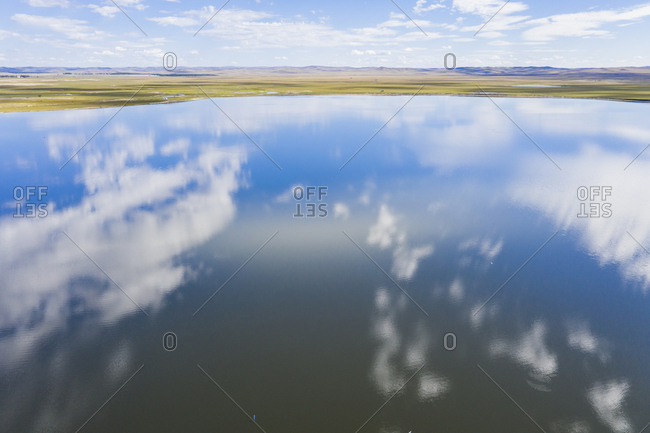 Lake like a mirror, reflect blue sky and white cloud