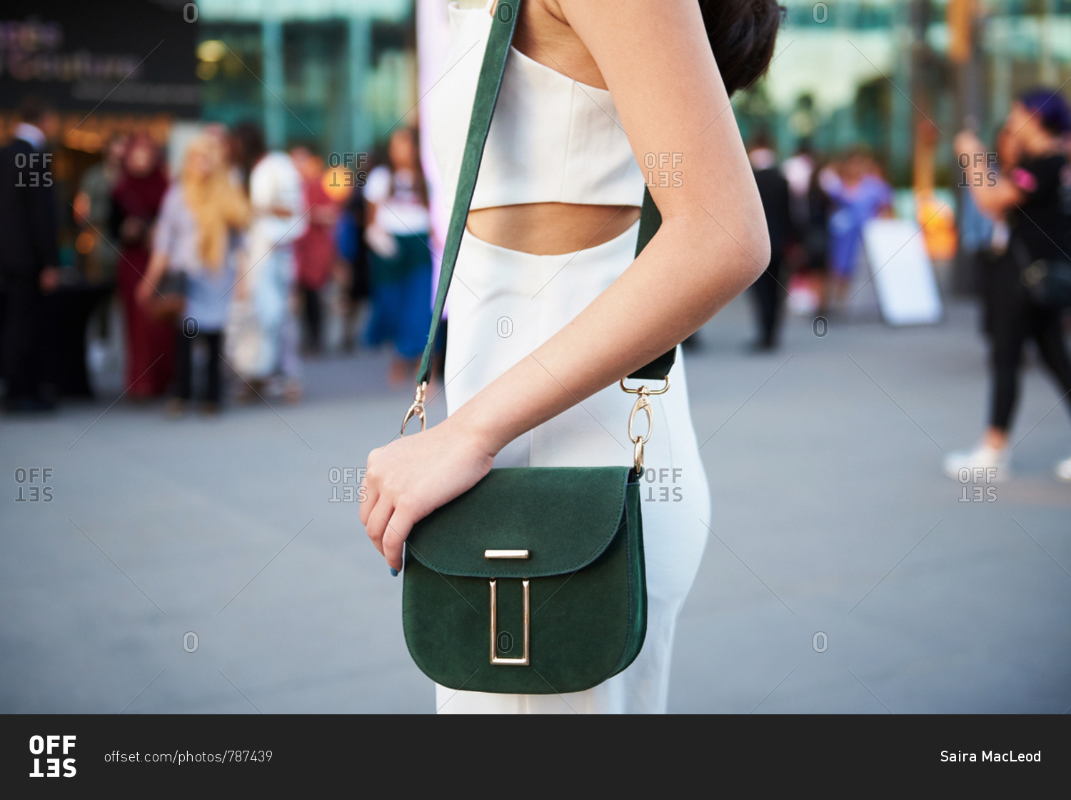 March 09, 2018- Melbourne, Australia: Fashion event guest wearing chic  summer outfit with dark green crossbody purse bag stock photo - OFFSET