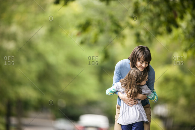 Mother hugging her daughter.