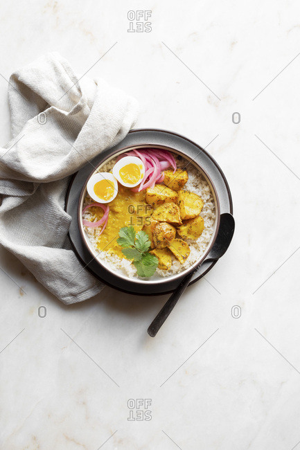 Dal, rice, potato, egg and onion - Indian vegetarian dinner.