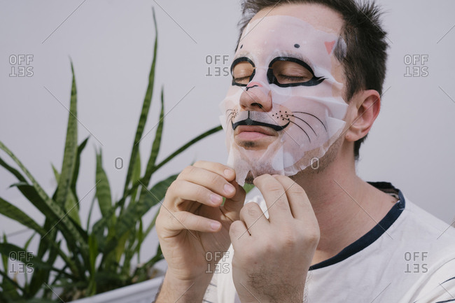 Man at home makes beauty face mask