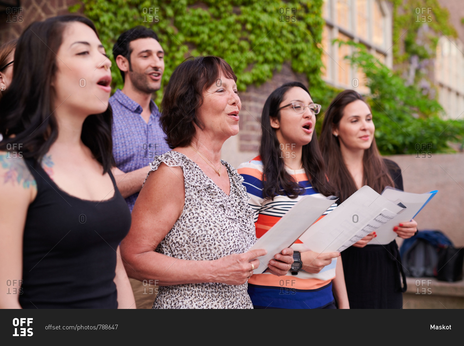 Multi-ethnic choir singers performing outside language school