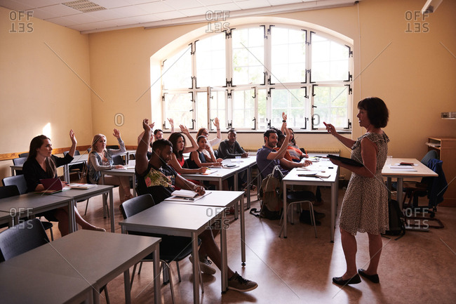 Teacher asking questions to students in language school