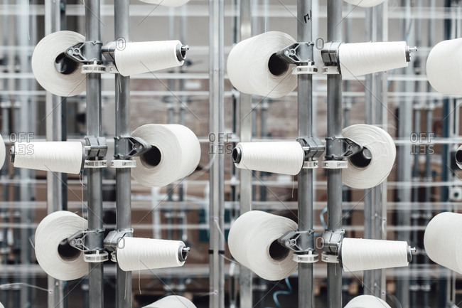 White thread spools in a factory
