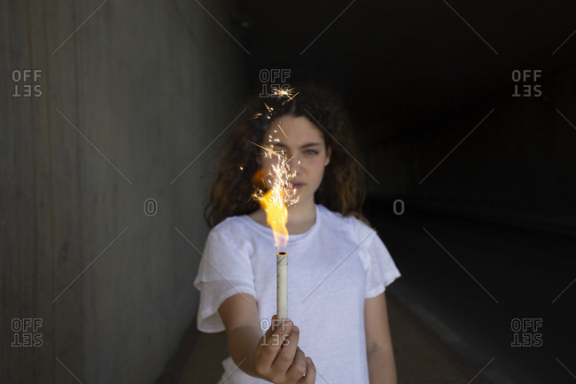 Girl holding sparkler in the dark
