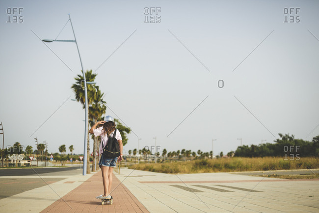 Girl skating- rear view