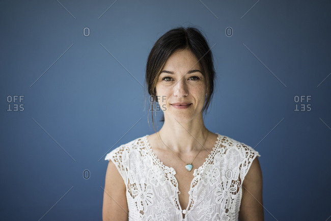 Portrait of a beautiful woman against blue background