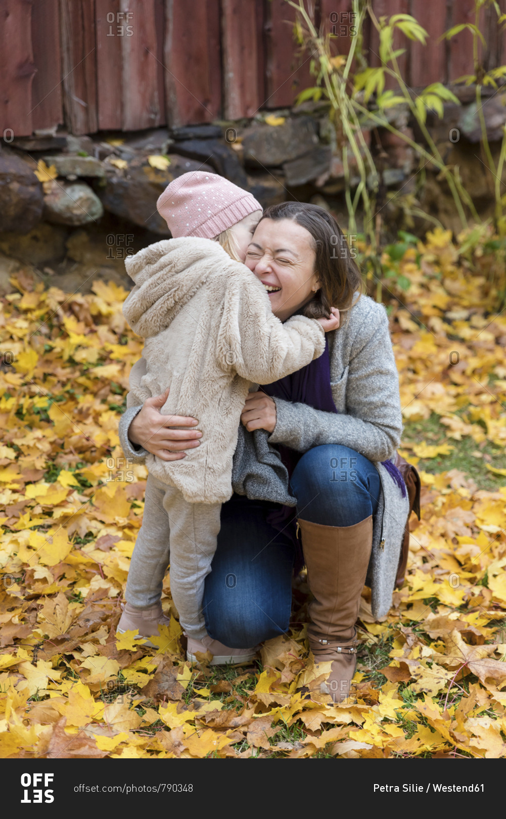 Finland- Kuopio- mother and little daughter cuddling together in autumn